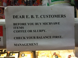 Gas station deli sign asking EBT customers to be mindful of their balances